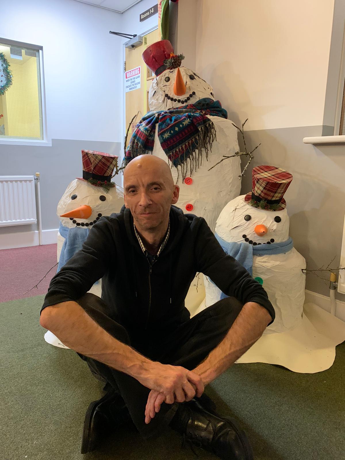 a man sitting in the hostel in front of decorations