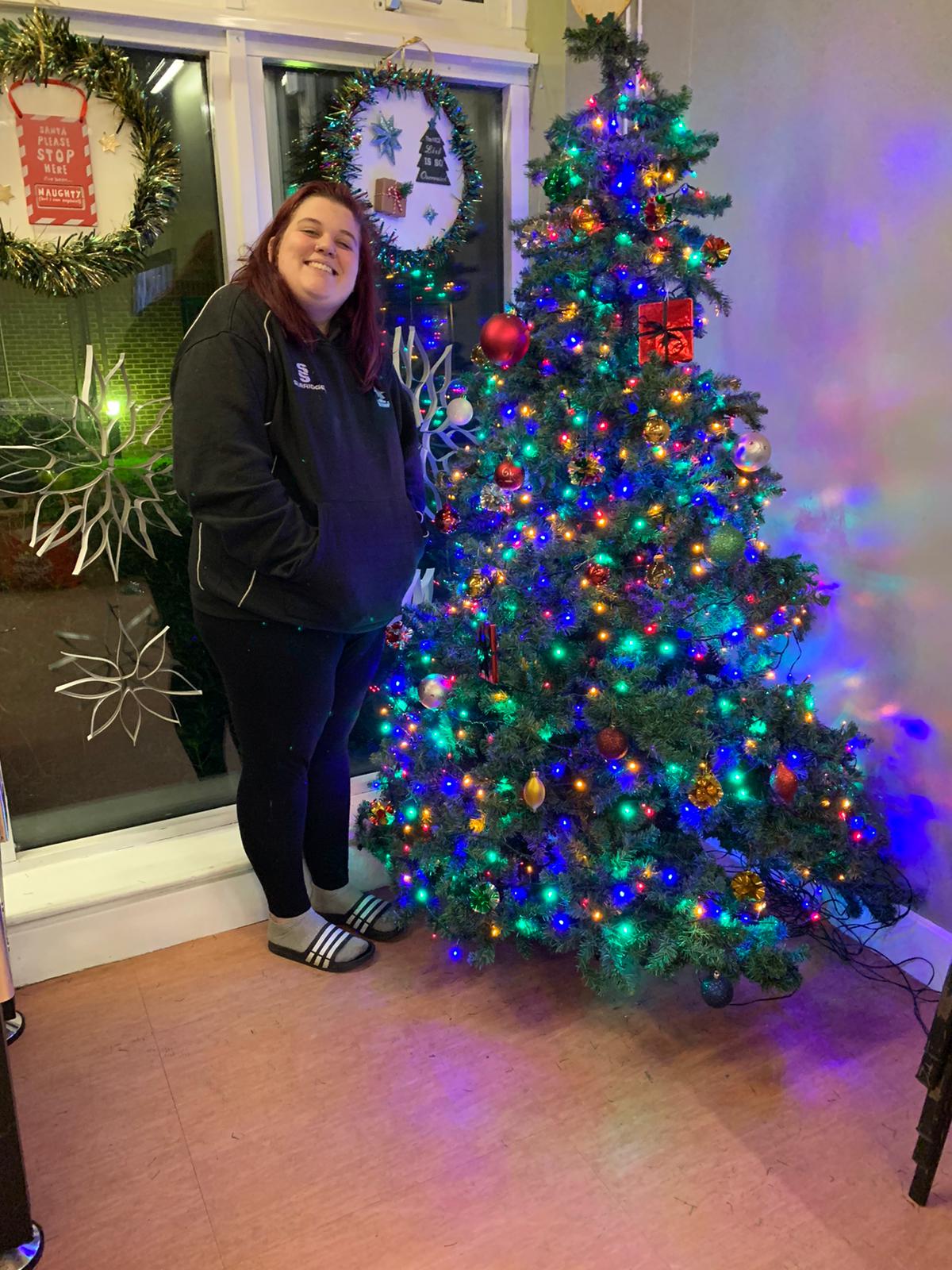 woman standing by a Christmas tree